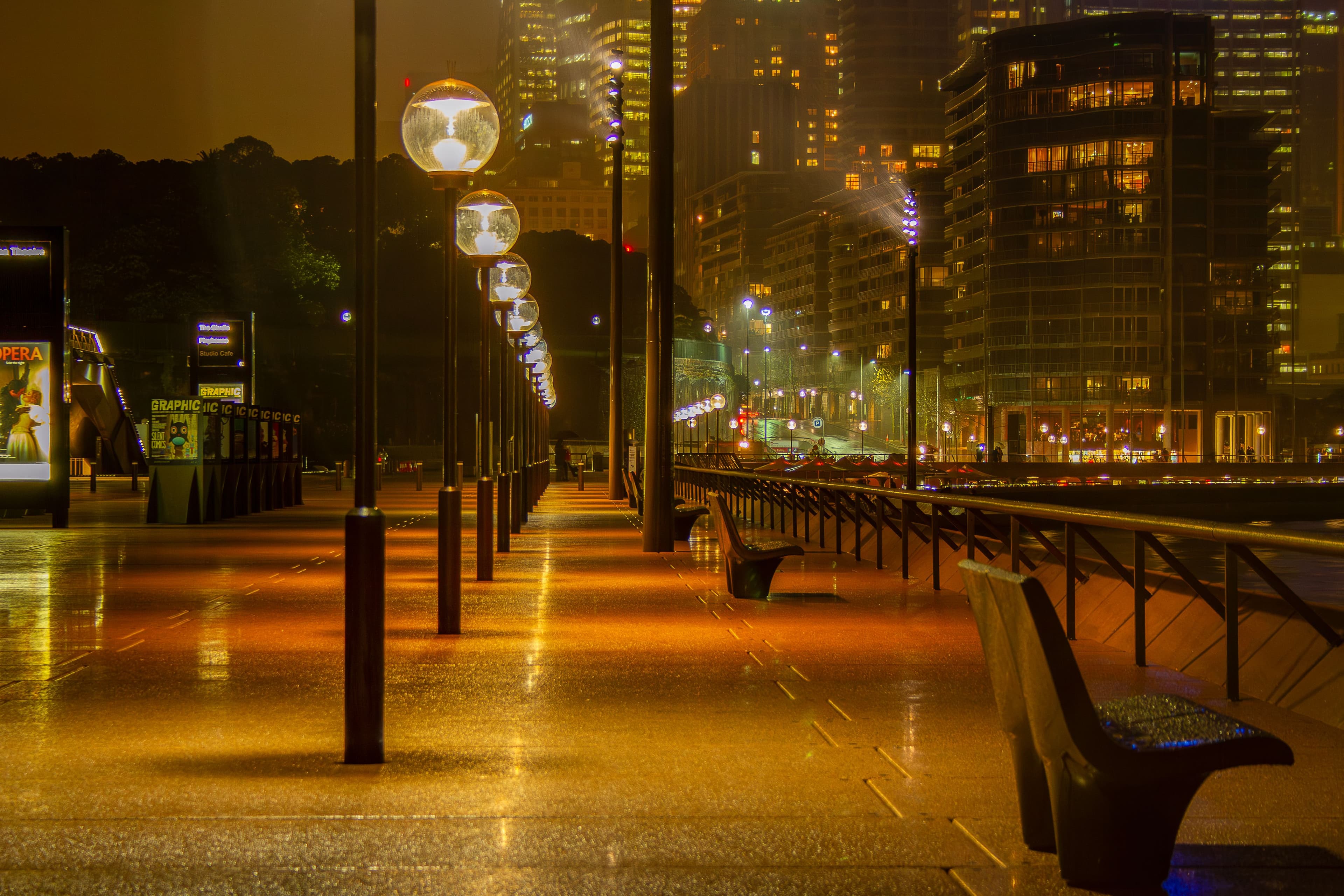 City walkway and towers lit at night
